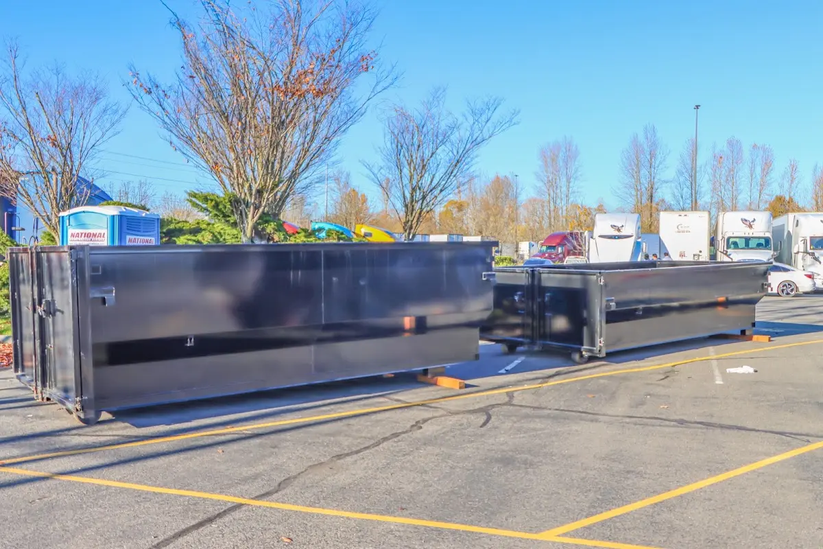 Professional dumpster rental service with roll-off container on residential driveway in Kirtland